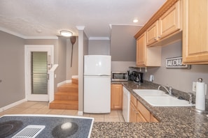 Enjoy cooking in this well-equipped kitchen with a central island, double sink, and ample storage.