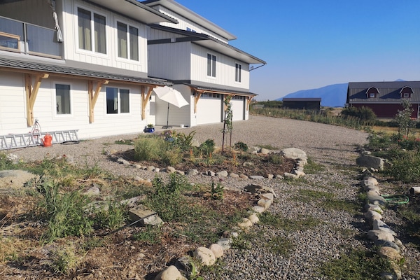 Garden in front of the house, suites are above the garages