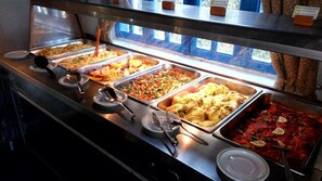 Enjoy a self-service meal with a variety of dishes, including pasta, creamy sauces, and fresh herbs.