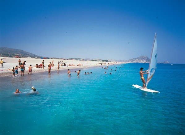 Guests can enjoy swimming, sunbathing, and windsurfing on the beach.