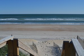 A beach with wooden walkways leading to the shore.