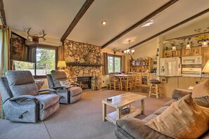 Cozy living area with a fireplace, comfortable seating, and dining space.
