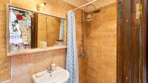 A bathroom with a shower, a sink, and a mirror. - Cava Doro Hotel (Rhodes)