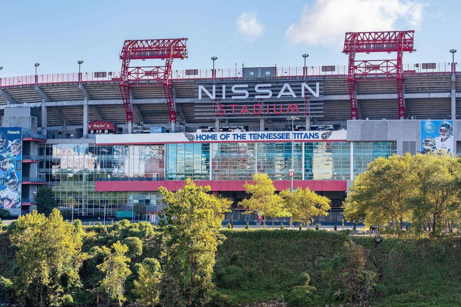 A stadium with a large 'NISSAN' sign and 'HOME OF THE TENNESSEE TITANS' text.
