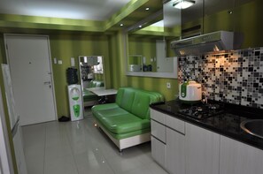 Apartment, 2 Bedrooms | Living area | LCD TV - Clean & Comfy Room at Bassura with open view window (Jakarta)