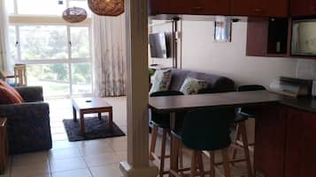 Apartamento conforto | Área de estar | TV de tela plana