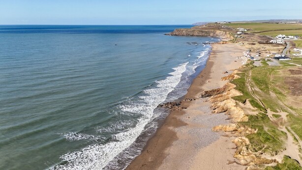 An aerial view of a coastal area with a beach, cliffs, and a small settlement. - Chi An Treth - sleeps 6 guests  in 3 bedrooms (Bude)