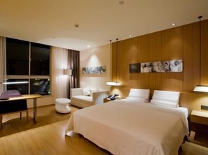 A hotel room with a large bed, a desk, a chair, a sofa, and a window. - Starway Hotel (Shanghai Anting Metro Station) (SHANGHAI)