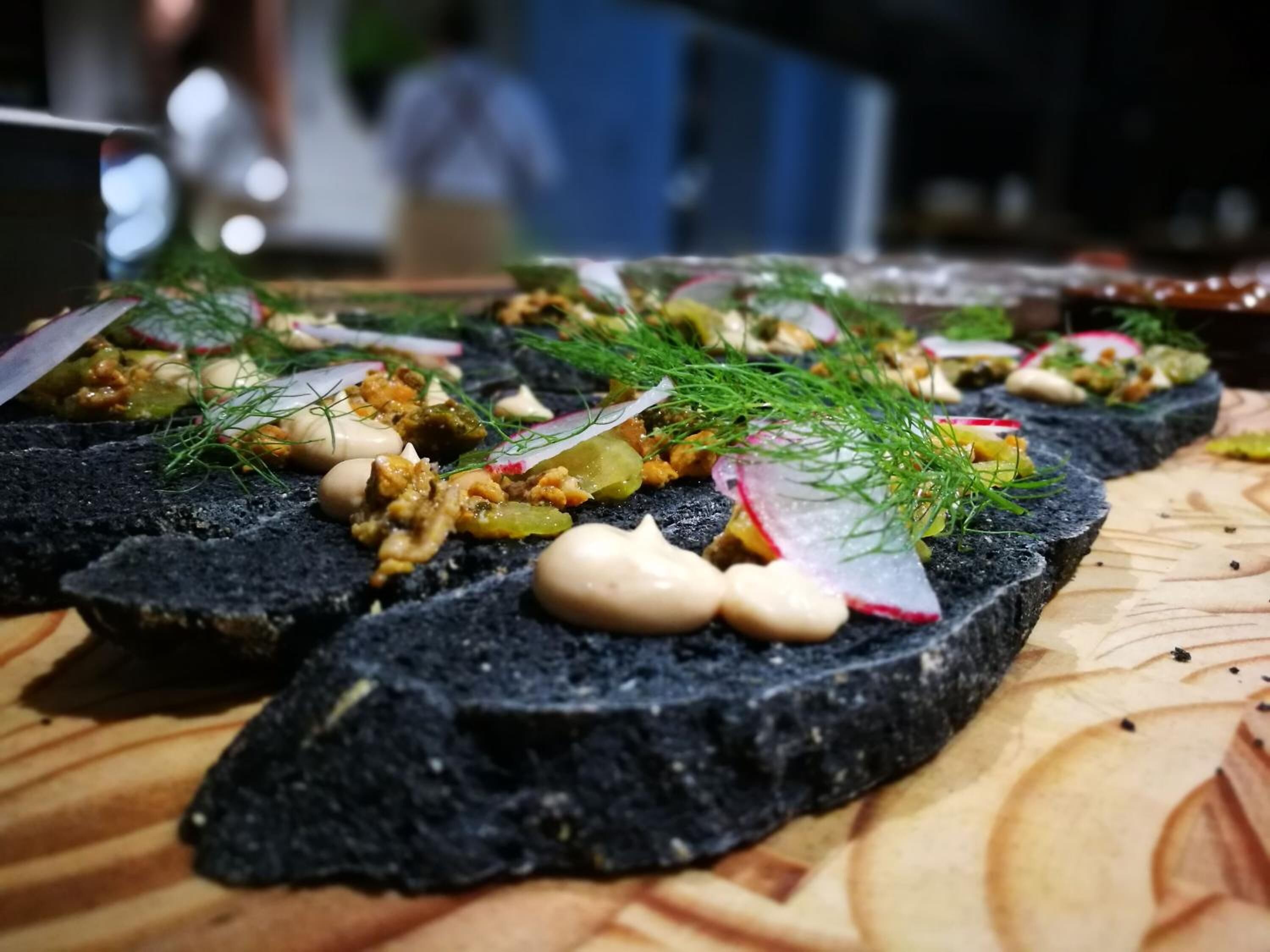 A wooden table with food items arranged on it.
