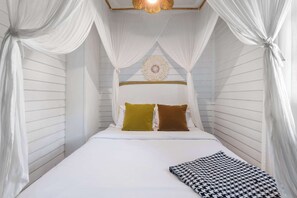 A bed with white bedding, two pillows, and a patterned throw. - Edgy Overlook (Atlanta)