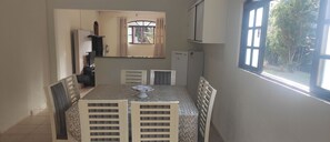 Enjoy meals with family and friends in this dining area, featuring a table for four and comfortable seating.
