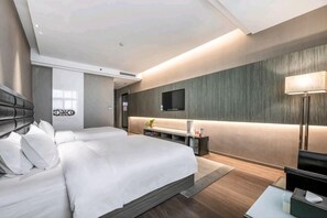 A modern hotel room with a large bed, a desk, a flat-screen TV, and a sofa. - Jindi Mingting Hotel (Lanzhou)