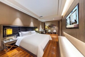 A hotel room with a large bed, bedside tables, a TV, and a wooden floor. - Jindi Mingting Hotel (Lanzhou)