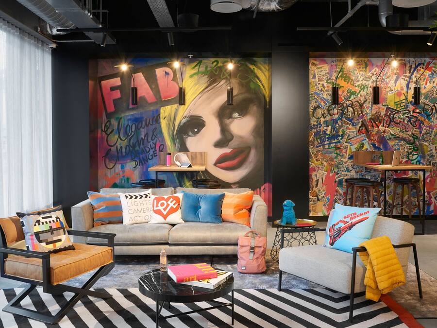 A modern living room with a sofa, armchairs, and a coffee table.