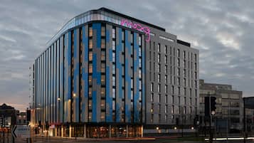 Hotel features a striking facade with a dynamic design and large windows.