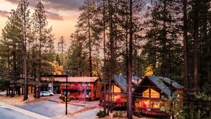 A rustic lodge with a wooden exterior, a covered porch, and a car parked in front. - Two-Cabin Buyout + 2 Hot Tubs | Walk to Snow Summit | Jumper & Jackhorn (Big Bear Lake)