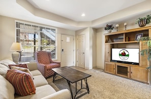Relax in this inviting living room with a sofa, coffee table, and TV.