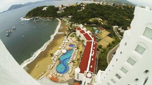 A resort with a beach, a swimming pool, and a view of the ocean and mountains. - Tesoro Manzanillo (Manzanillo)