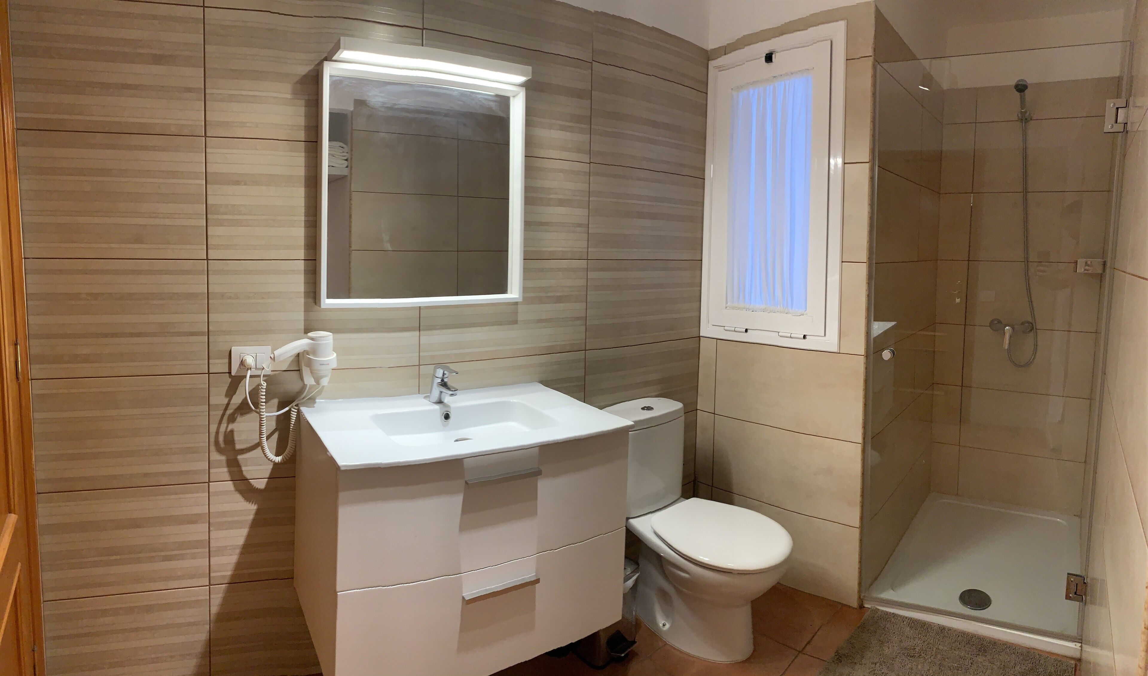 Shower, hair dryer, towels, toilet paper