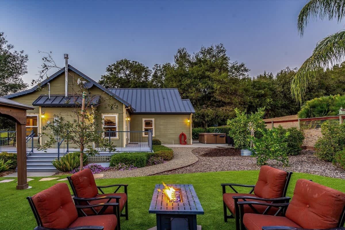 A house with a patio, outdoor seating, and a fire pit.