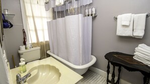 Une salle de bain avec une baignoire, un lavabo, des toilettes et un porte-serviettes.