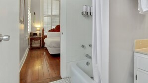 A bathroom with a bathtub, a toilet, and a sink.