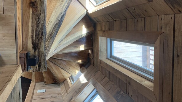 A wooden attic room with skylights and a sloped ceiling. - Cozy Cabin on the River (D'Iberville)