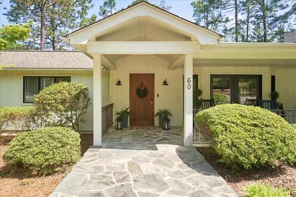 A house with a stone front porch, a wooden door, and a number '60' on the right. - Spacious:  swimming pool, walk to the village. (Pinehurst)