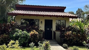 A single-story building with a tiled roof and a door marked with the number 303. - Rancho Casa Grande (Quepos)