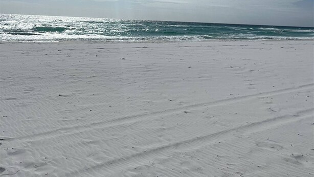 A beach with a clear sky and sunlight reflecting off the water. - 8F, Isle Be Back (Destin)