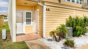 A yellow building with a white door and a number '4A' on the side. - 4A, Castaway Cove (Destin)