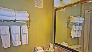 A bathroom with a toilet, sink, and towel rack.