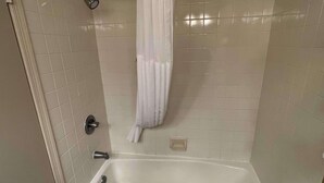 A bathroom with a bathtub, a shower, and a toilet.