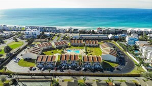 A coastal resort with a central pool, multiple buildings, and a view of the ocean. - 9G, Tan Lines & Good Times (Destin)