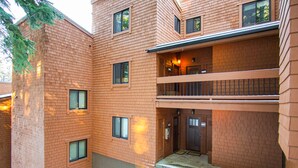 A multi-story brick building with a central entrance and a balcony on the second floor. - Northstar - Ski Trail Condo (Truckee)