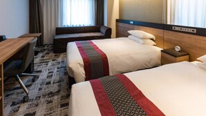 A hotel room with two beds, a desk, a chair, and a window with curtains. - Kazusaya Hotel (Tokyo)