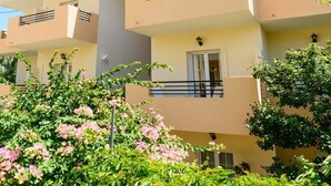 A multi-story residential building with balconies, windows, and greenery. - Argyro Apartments (Agios Nikolaos)