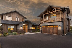 Stunning two-story house with a garage and balcony.