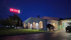 A building with a sign reading "BUFFALO LODGE HOTEL" and a large arched window structure.
