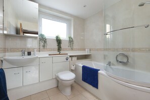 Bathtub, hair dryer, towels, soap