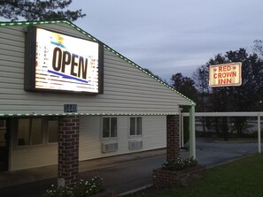 A building with a large illuminated 'OPEN' sign, a 'Red Crown Inn' sign, and a number '4440' on the side. - Red Crown Inn (Laurel)