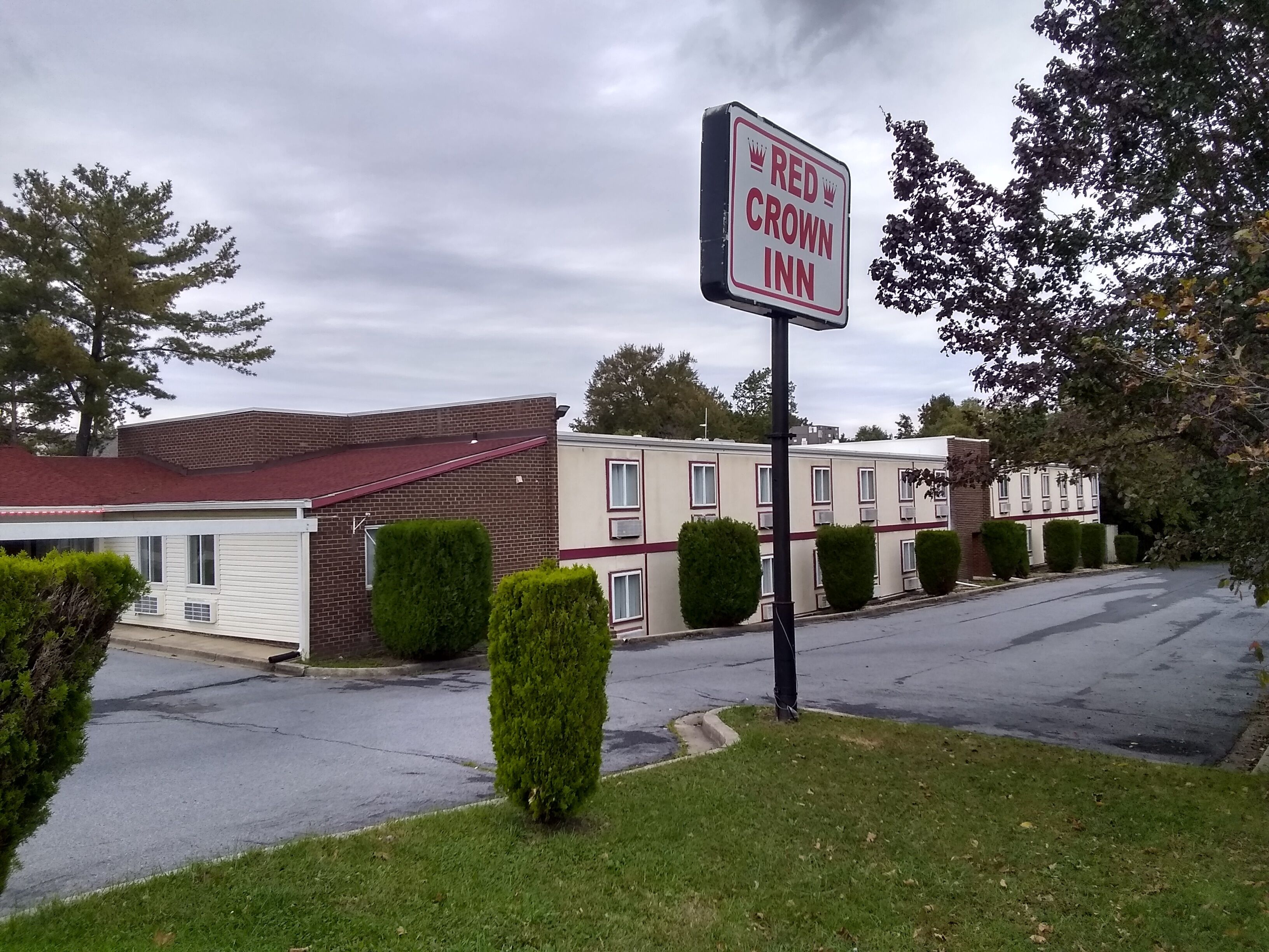 A Red Crown Inn with a brick facade and a red roof.