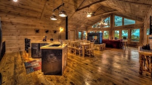 A spacious cabin with a large kitchen area, dining space, and a cozy living room with large windows. - Serenity Peak | Mountain View | Close To Town | Paved | Dog Friendly (Blue Ridge)