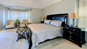 A bedroom with a bed, two bedside tables, a nightstand, a ceiling fan, and a window with curtains. - Whole house with a Texas sized lot (Pflugerville)