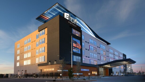 A modern hotel with a prominent 'Ally' sign, multiple floors, and a covered entrance. - Aloft by Marriott Lubbock (Lubbock)