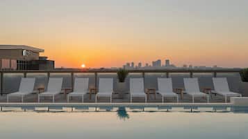 Outdoor pool, open 5:00 AM to 11:00 PM, sun loungers