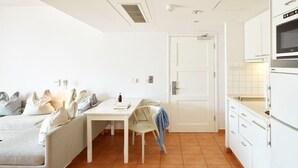 A compact living space with a kitchenette, a dining area, and a sofa. - Sunwing Sandy Bay Beach (Ayia Napa)