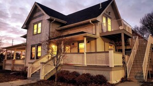 A two-story house with a covered porch, a staircase, and a fenced yard. - Best Location in town!!! Steps from coffee, bars, shops, river and Czech  - Pets ! Arcade (Cedar Rapids)