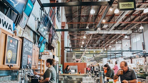 An indoor market with various stalls and a bar area. - Best Location in town!!! Steps from coffee, bars, shops, river and Czech  - Pets ! Arcade (Cedar Rapids)