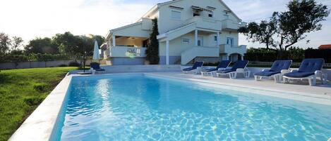 Seasonal outdoor pool, pool umbrellas, pool loungers